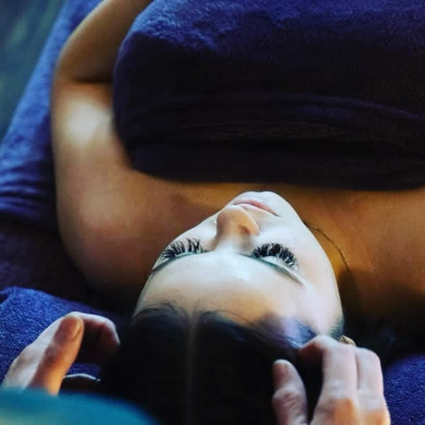 Heather perfoming holistic facial treatment